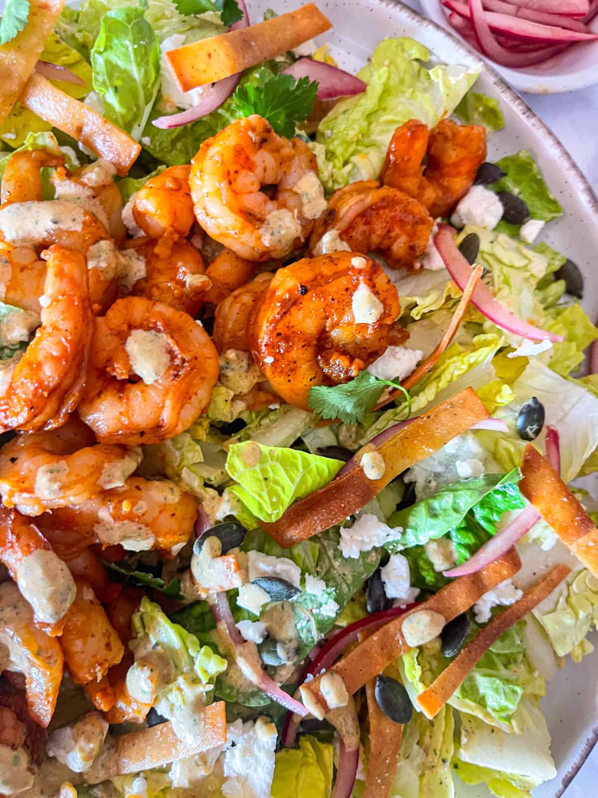 salad built and drizzled in dressing.