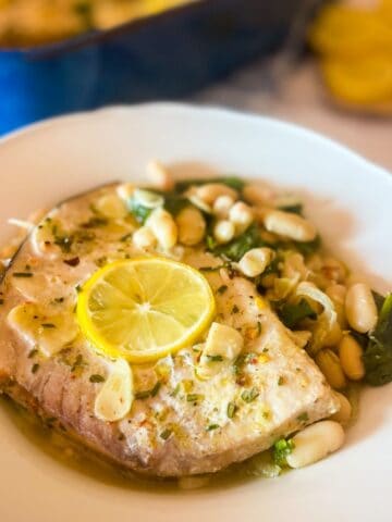 finished recipe served in a white bowl garnished with lemon slices