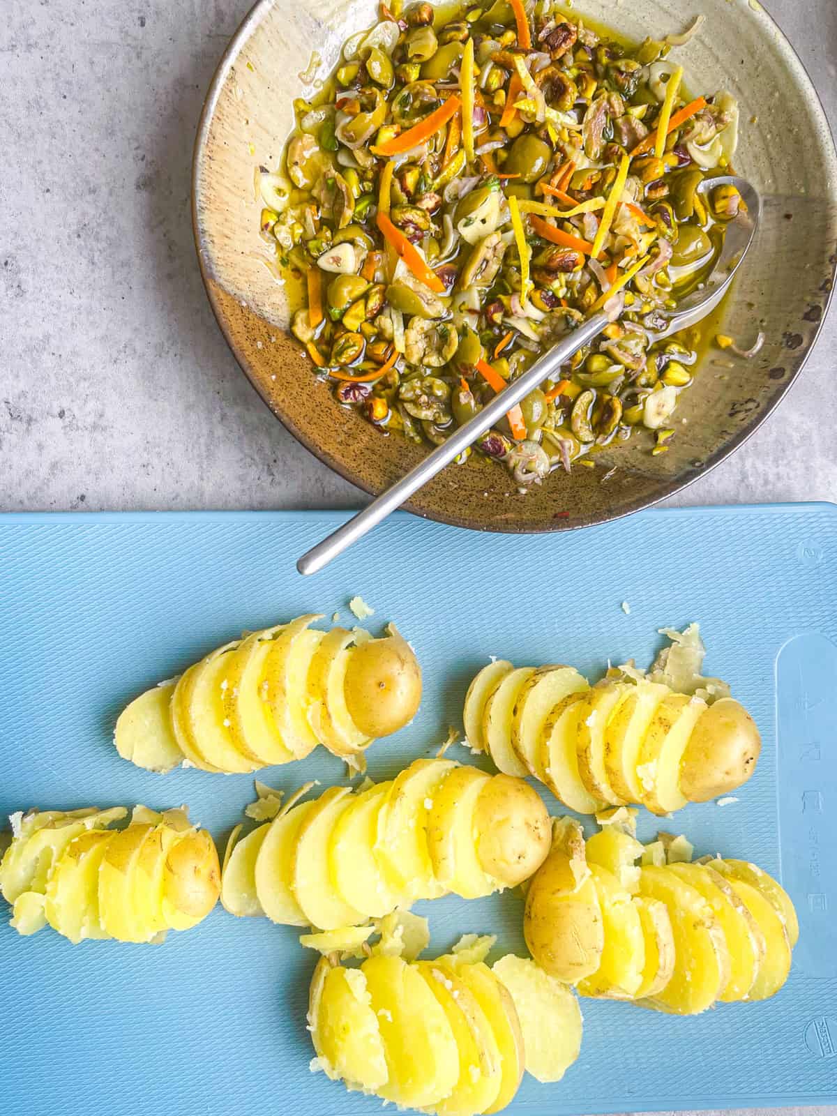 Olive tapenade and sliced potatoes prepped for Baked Grouper Packets.
