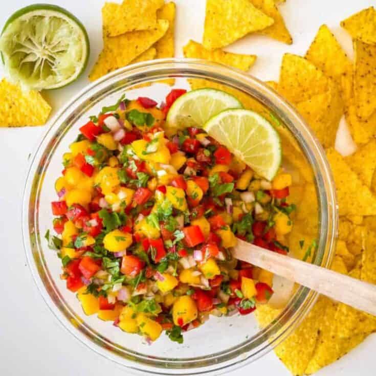 finished recipe piled high in glass bowl garnished with lime slices.