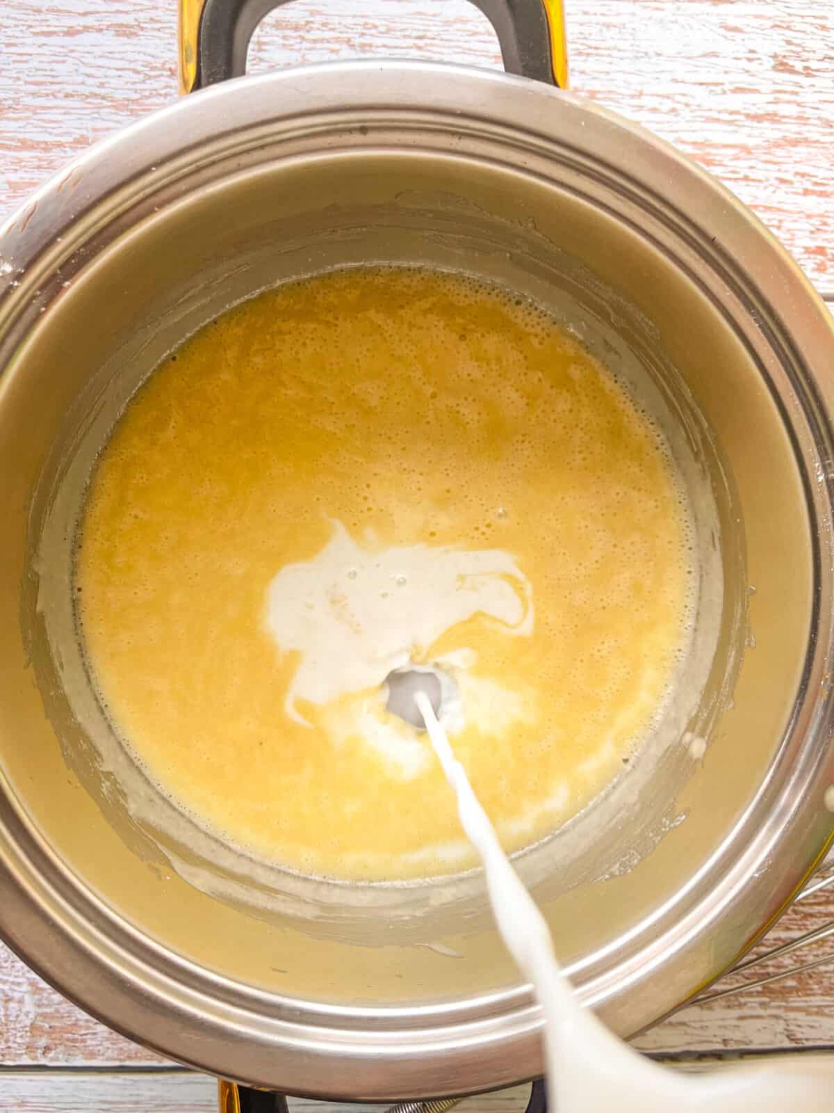 milk added to the sauce pan of roux.