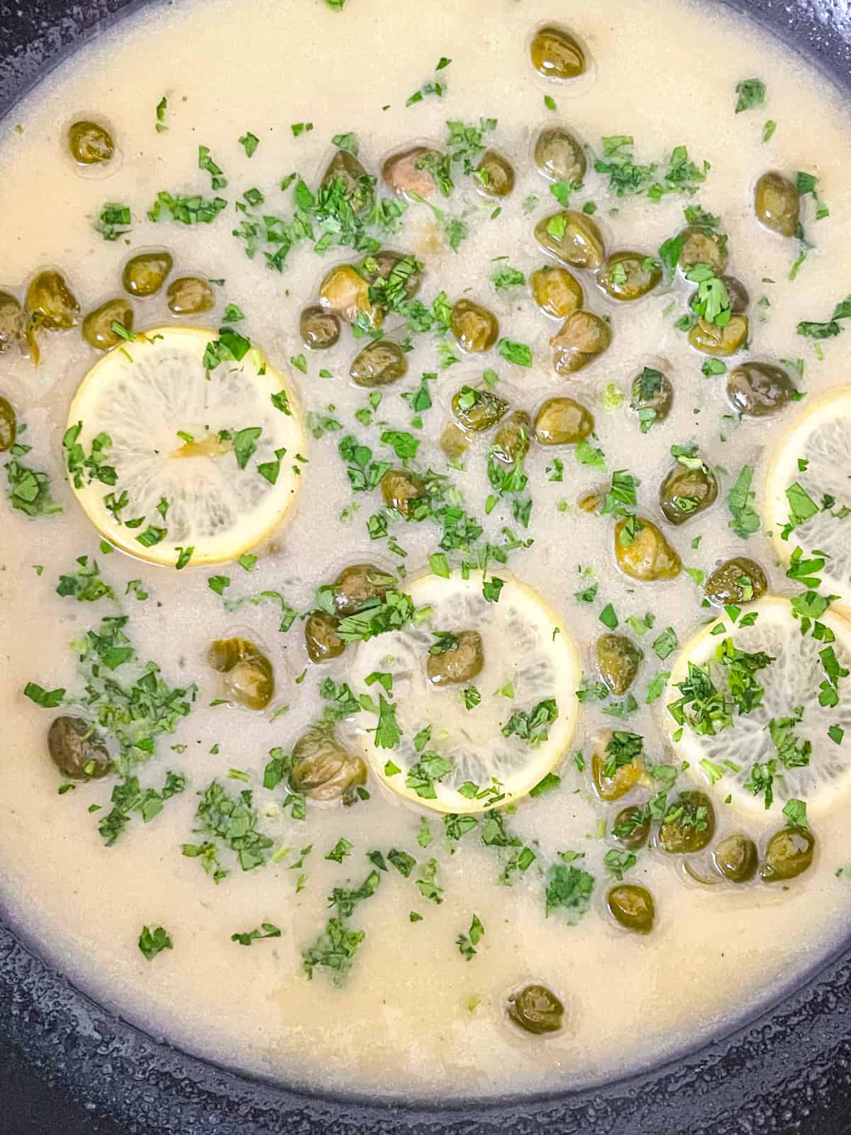 diced parsley added to sauce in skillet.