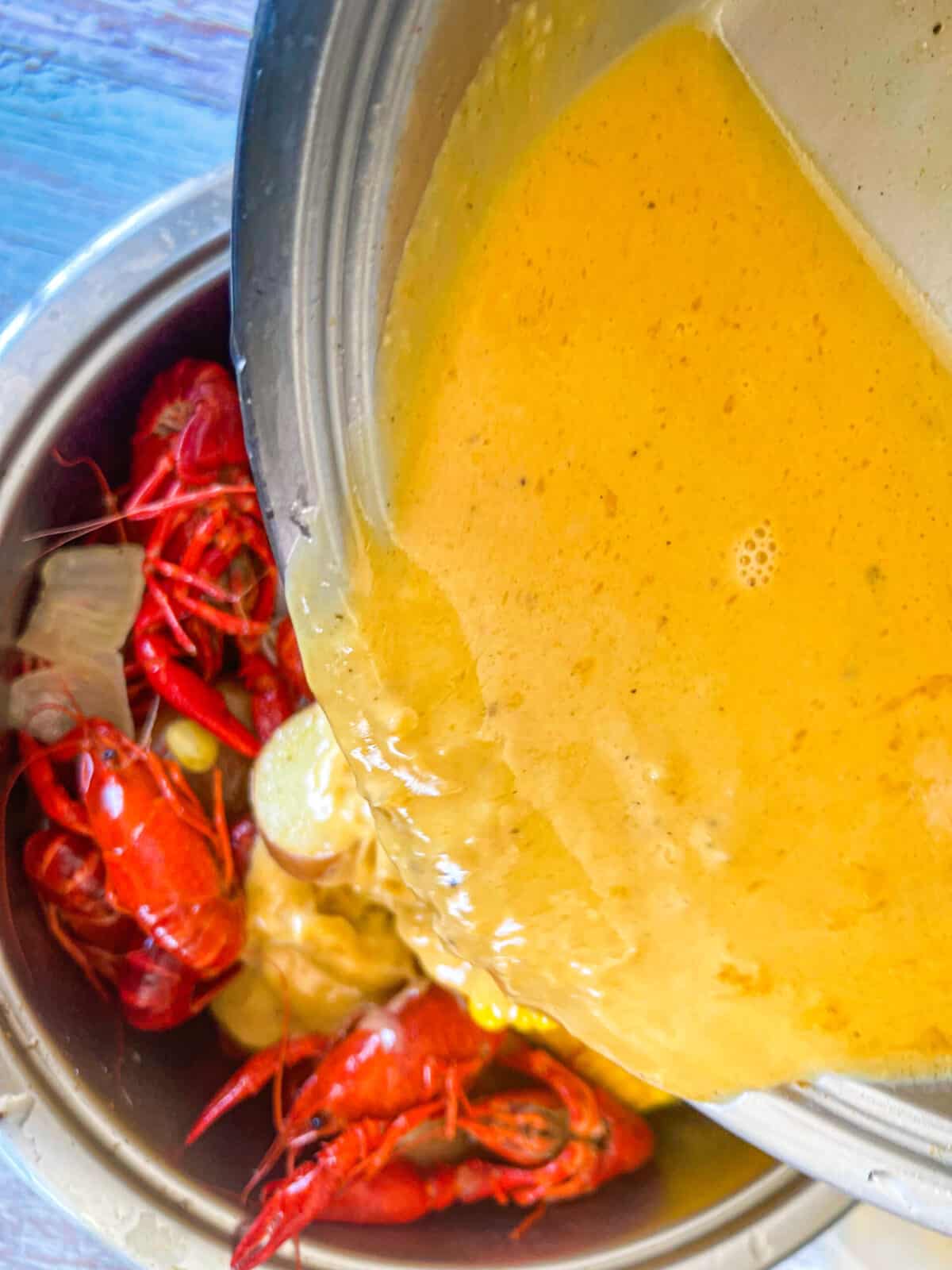 cajun sauce poured over crawfish boil.