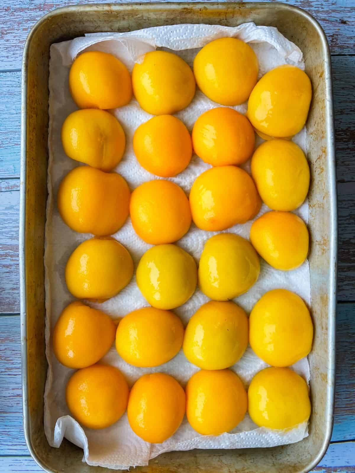 peaches draining over paper towels.