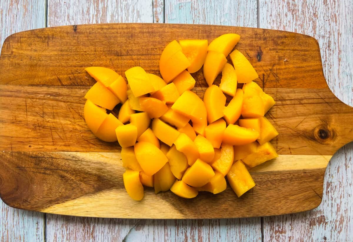 peaches diced on a cutting board.