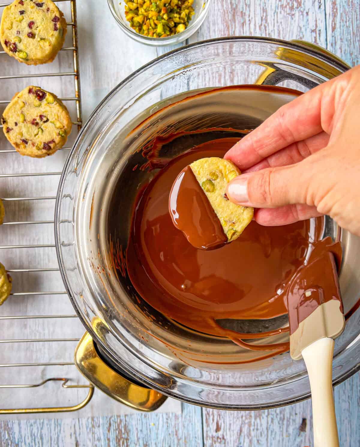 pistachio cookie dipped in melted chocolate