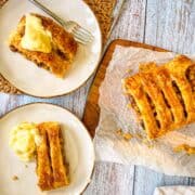 finished recipe served on a wooden board with two slices cut out and plated with ice cream