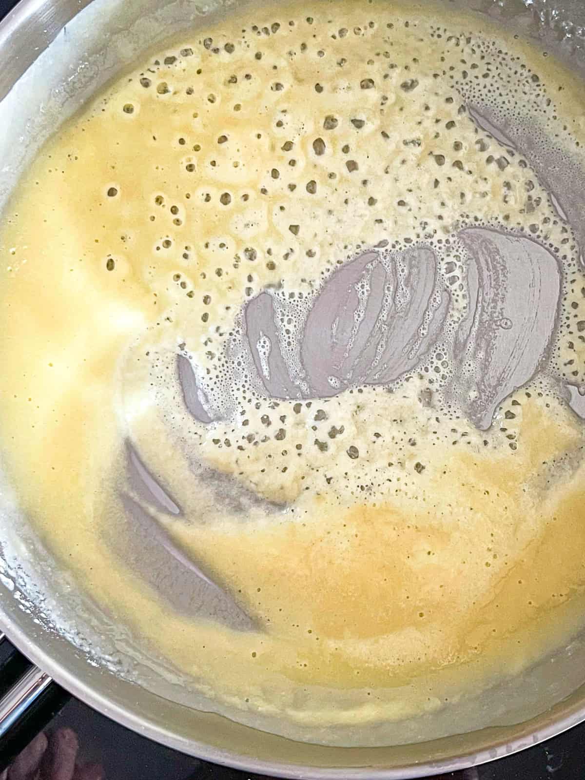 roux bubbling up in a sauce pan.