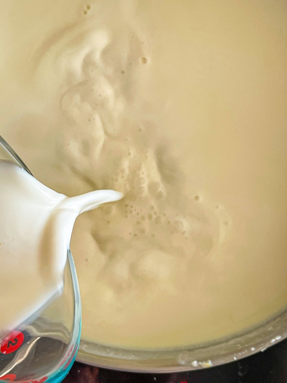 adding milk to roux.