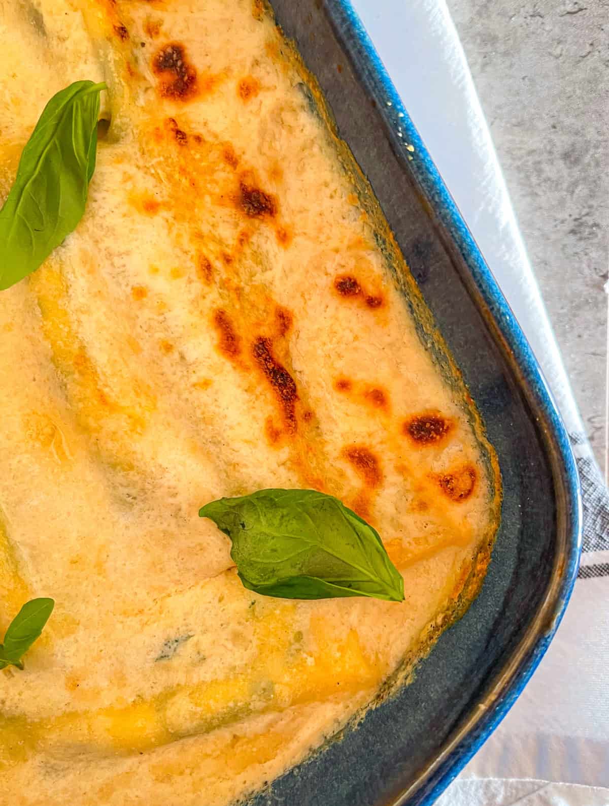 finished seafood cannelloni garnished with fresh basil.