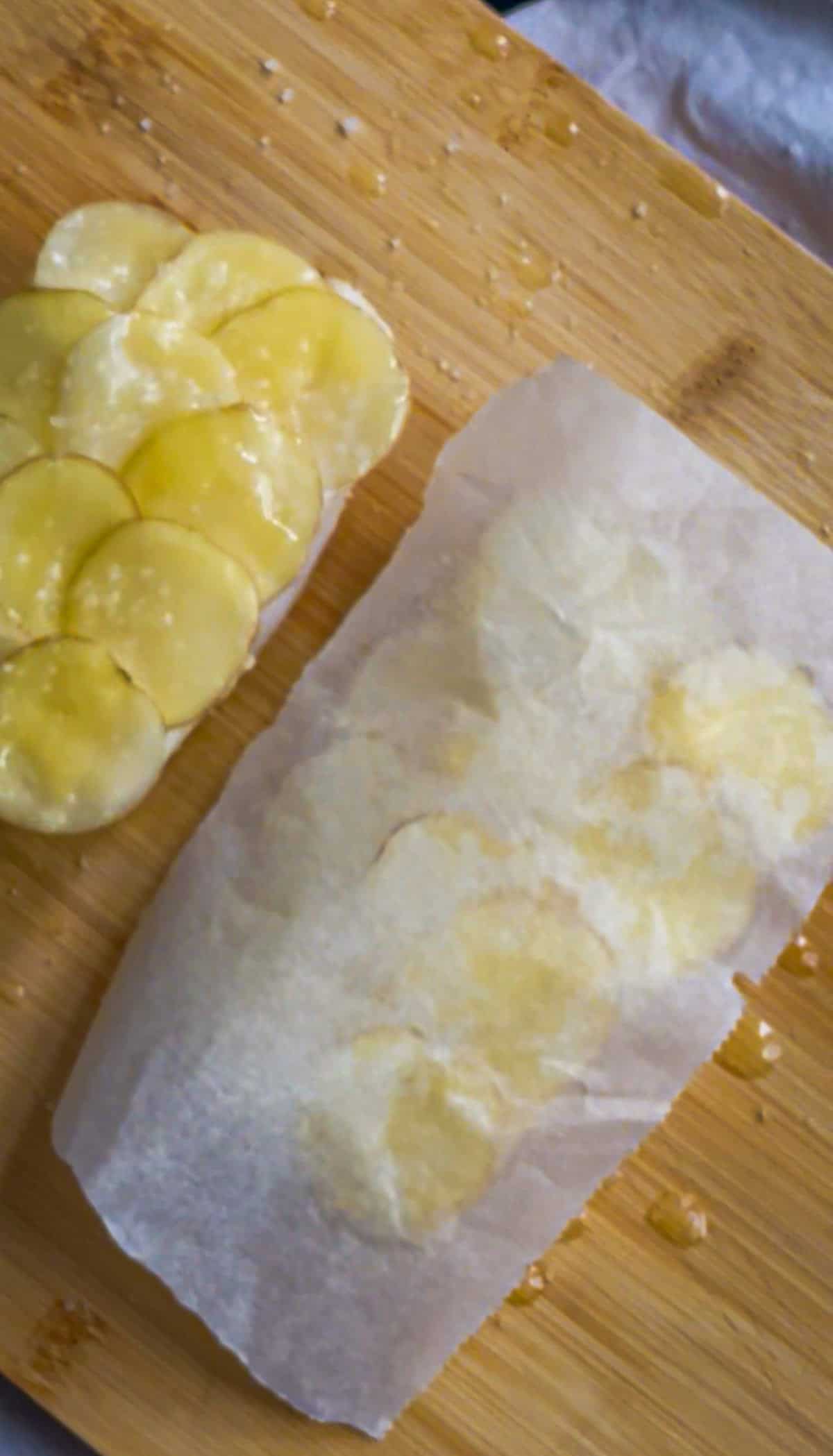 Small piece of parchment used to cover each potato-crusted fillet of fish before refrigerating.