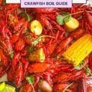 pinterest pin showing a seafood boil spread across a table garnished with lime wedges and herbs.