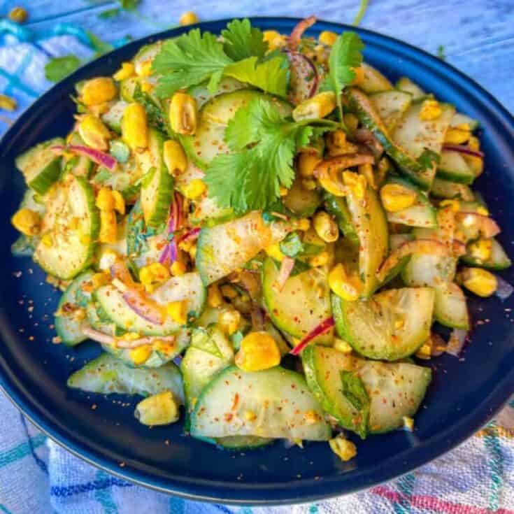 finished recipe piled high on a black plate and garnished with whole cilantro leaves.