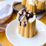 Coffee jello with whipped cream on a plate.