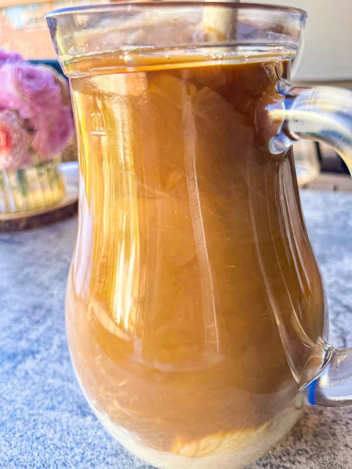 stirring creamy sweetened milk into black coffee.