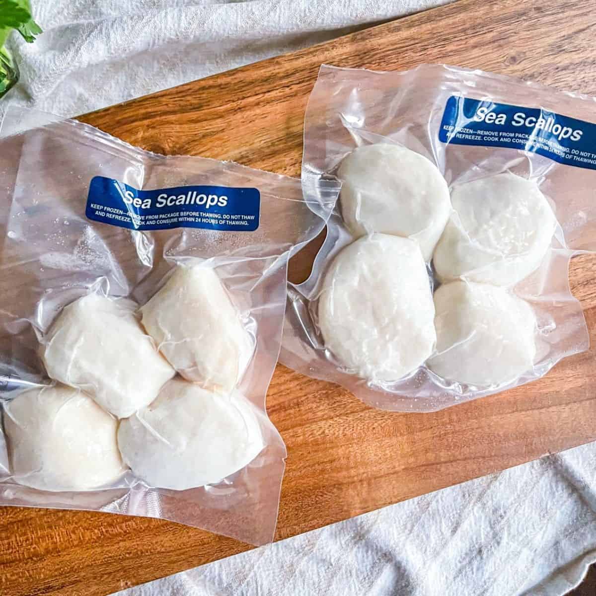 two packages of frozen sea scallops from Sizzlefish.