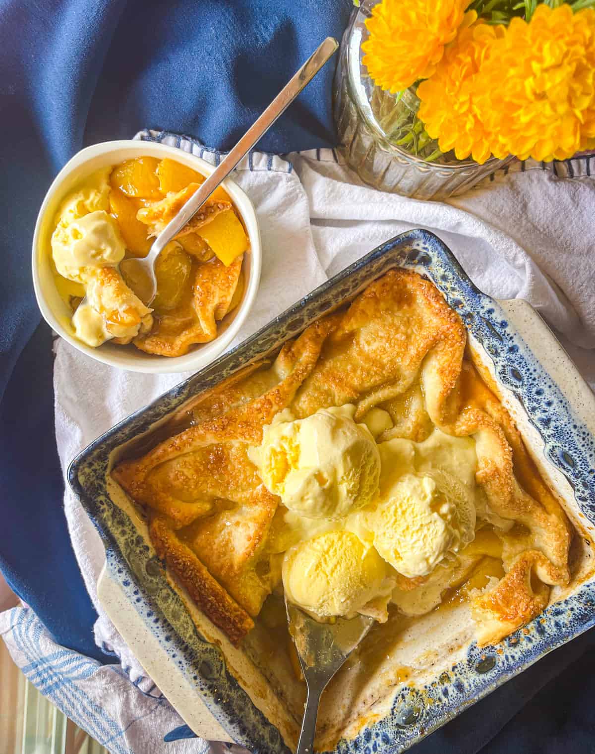 finished dish served with ice cream in a small bowl and in the baking dish