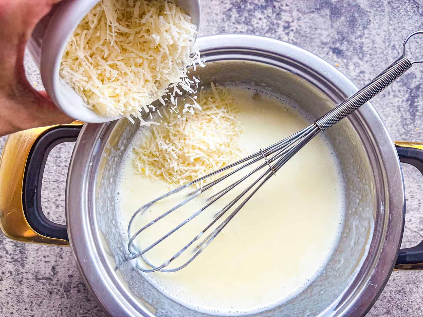 Parmesan poured into milk