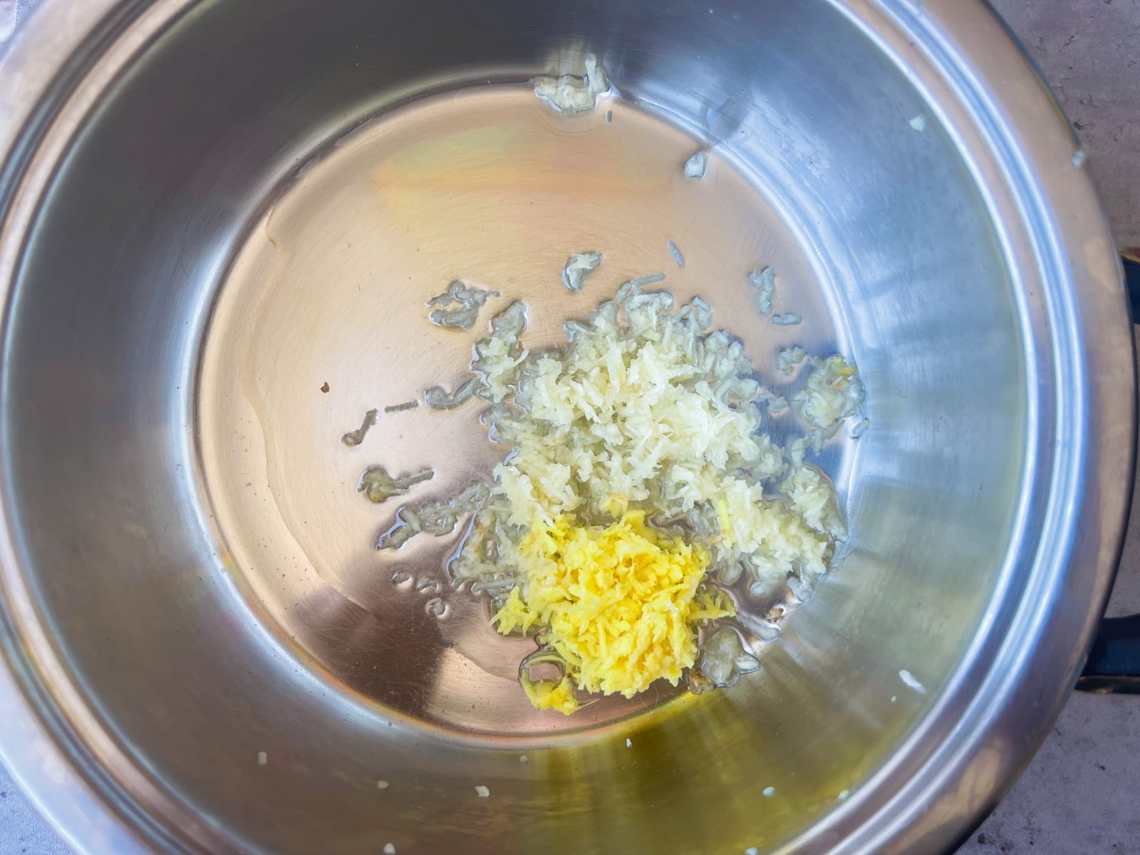 garlic and ginger sautéing in a pot