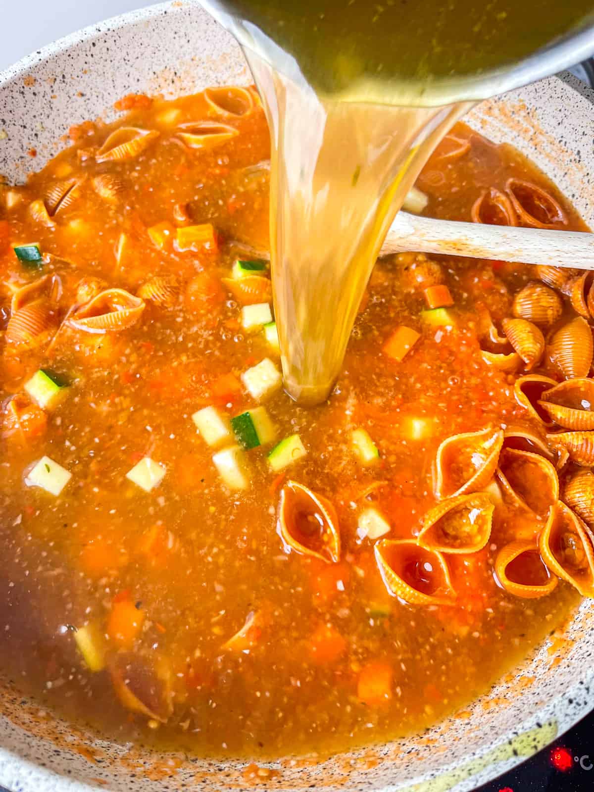 stock added to pot of shells and veggies