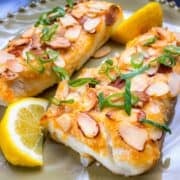 2 pieces of Almond crusted haddock on a plate.