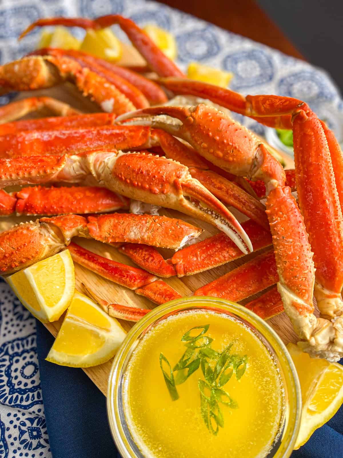 wooden platter piled high with bright red crab legs.