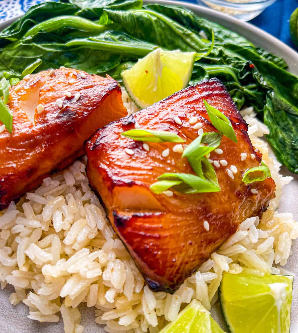 air fried cod fillets on a bed of rice and side of greens.