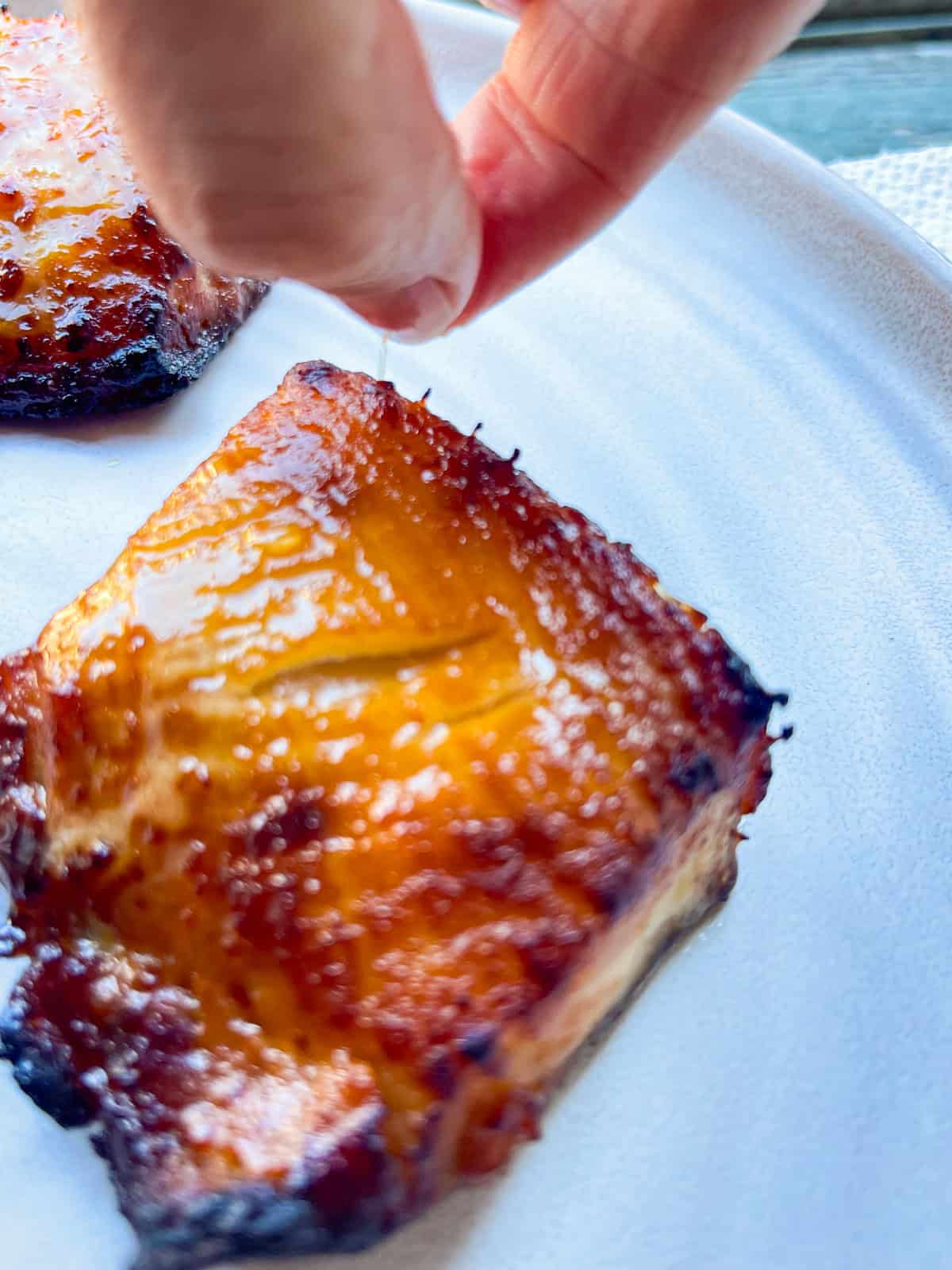 pulling pin bones easily from the side of the air fried fish fillet.