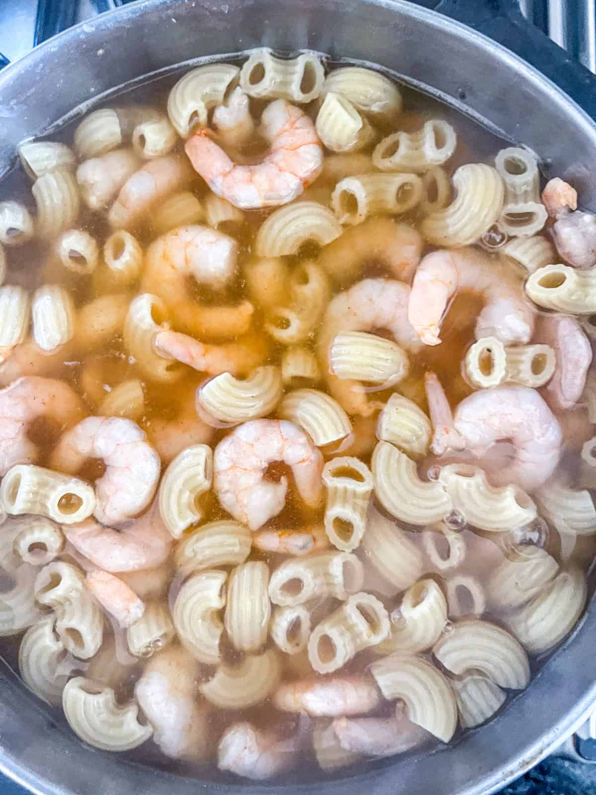 Shrimp poaching in pasta water.