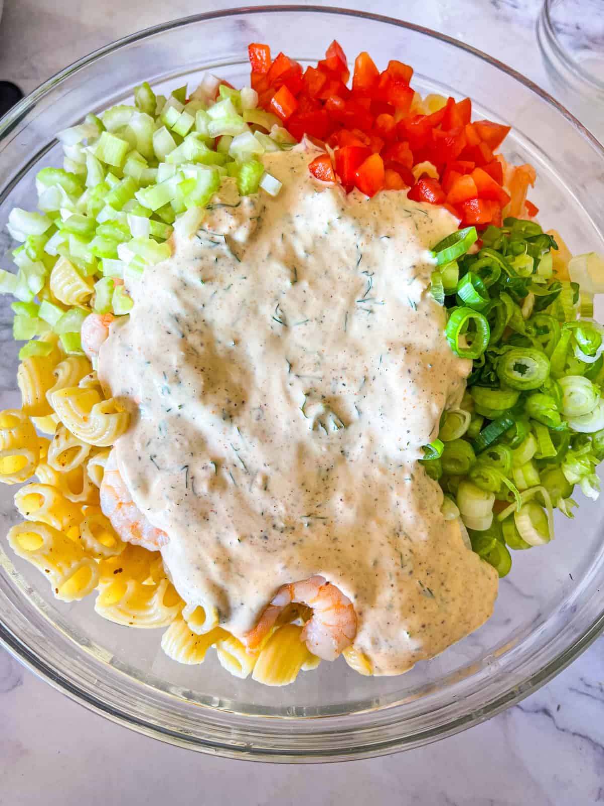 All ingredients for shrimp pasta salad in a bowl.