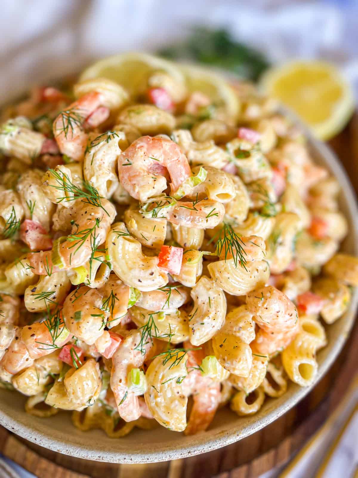 Shrimp macaroni salad in a bowl garnished with dill.