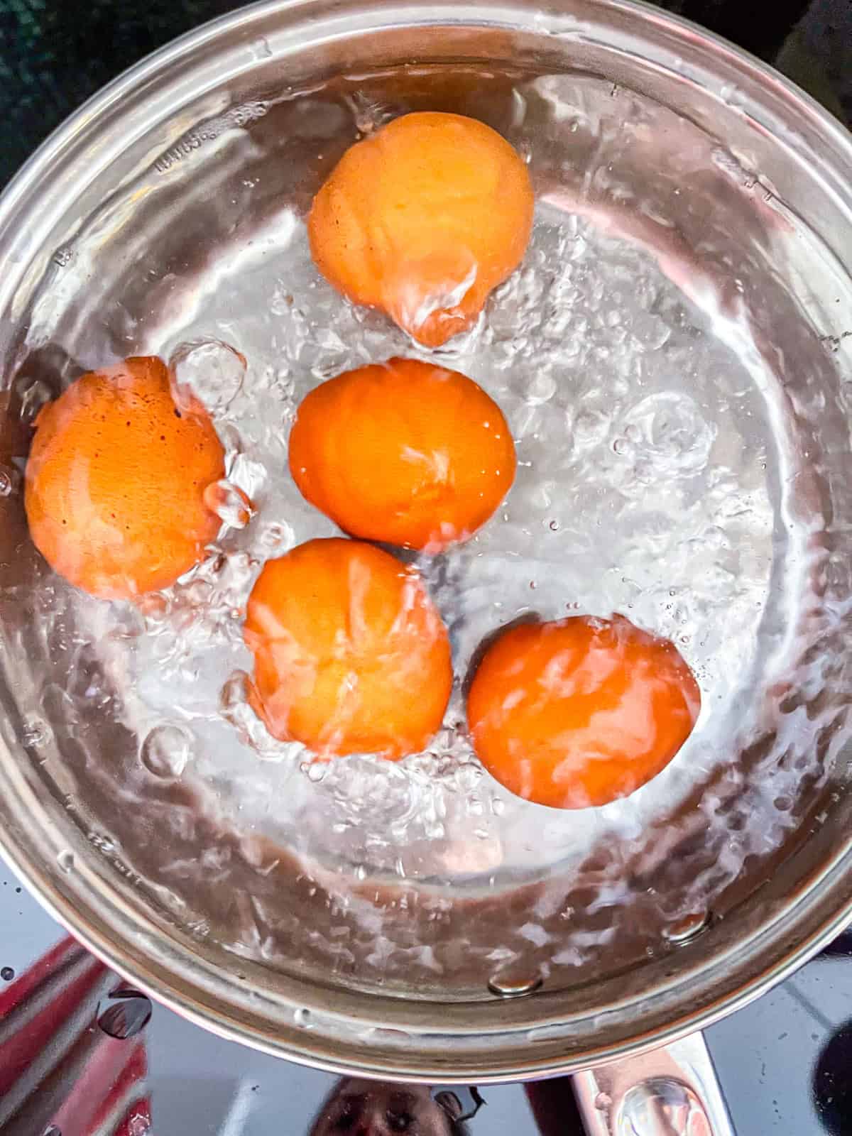 Eggs boiling in a pan.