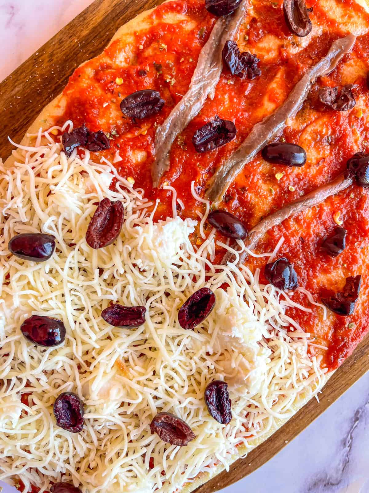 Anchovy Pizza with cheese, olives and sauce.