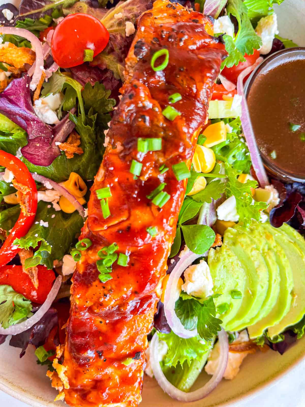 Grilled bbq salmon on a salad.
