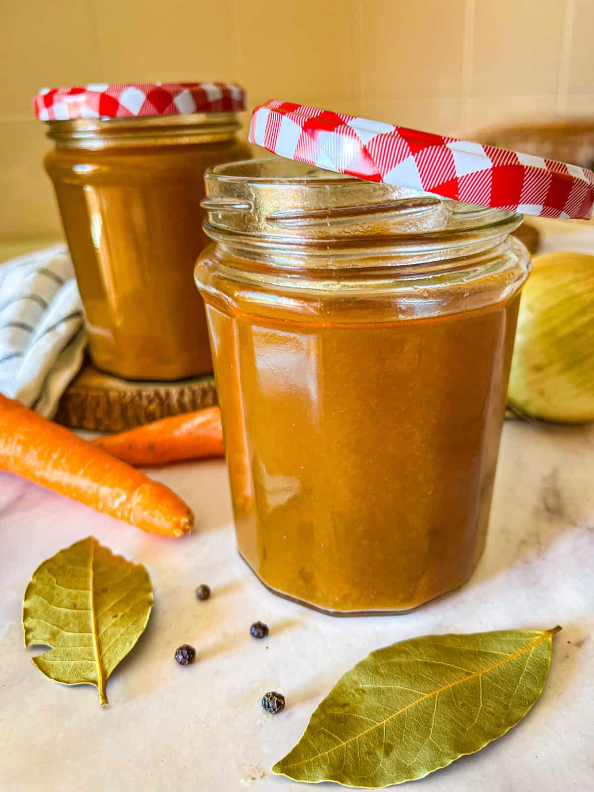 2 jars filled with stock on a table.