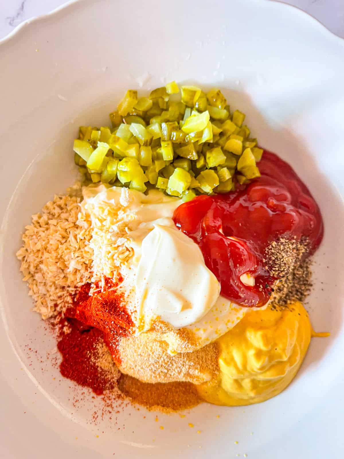 All ingredients for burger sauce in a bowl.