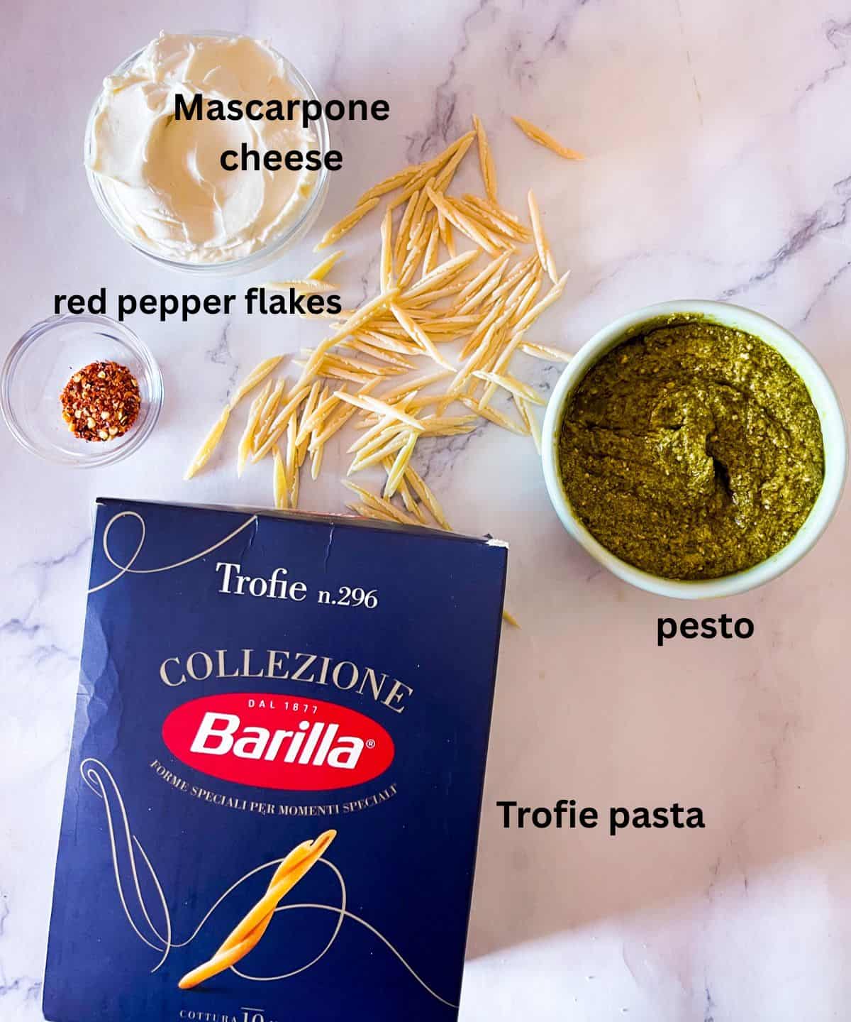 Ingredients pesto pasta on a table.