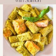 pesto pasta with salmon in a bowl.