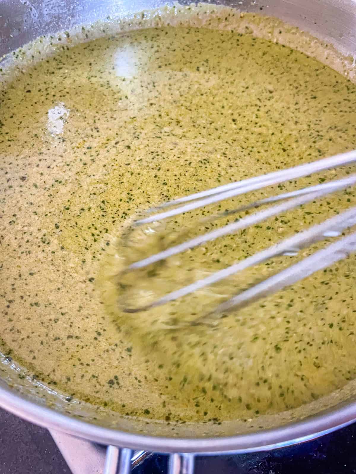 Sauce whisked in pan.