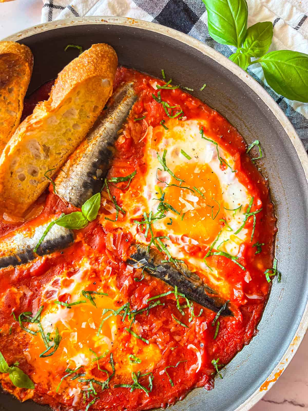 Sardine in purgatory laid out on a table.