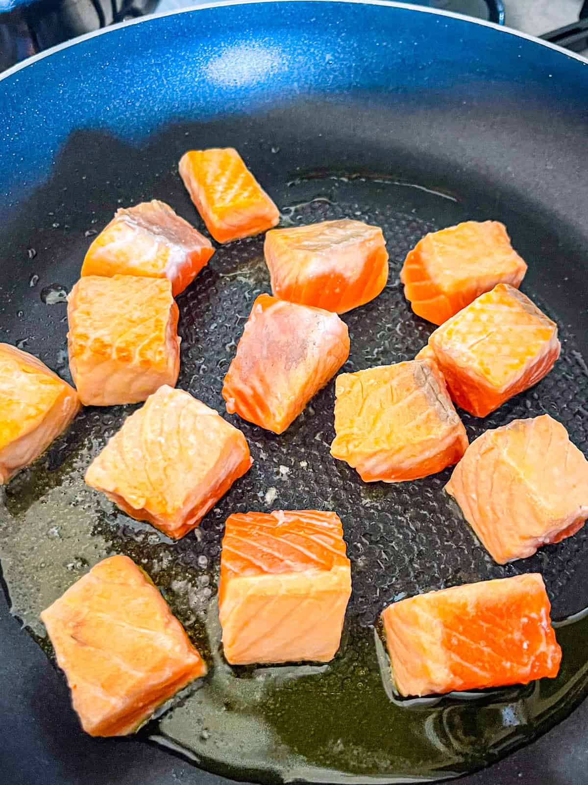 Salmon cooking in a skillet