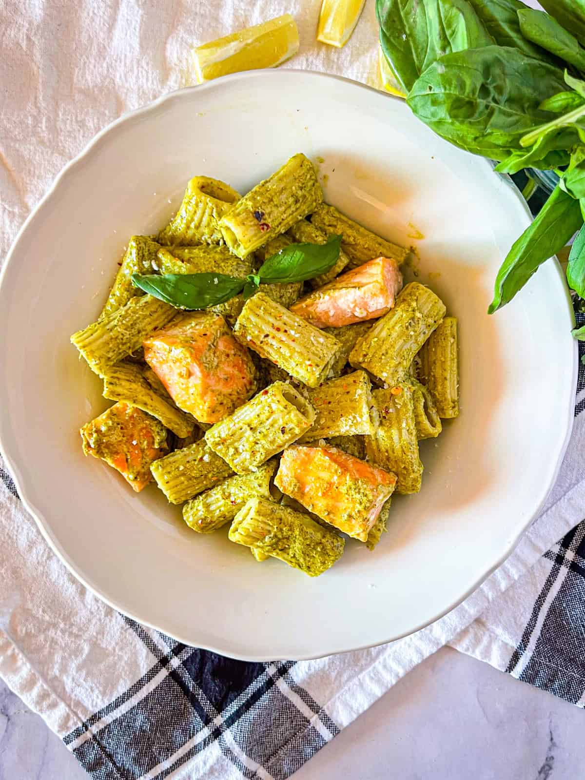 pesto rigatoni with salmon in a bowl.