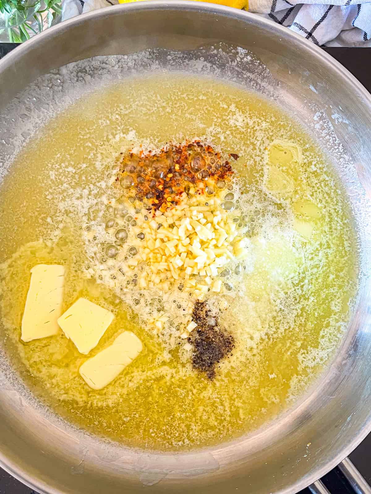 Butter, garlic and spices in a skillet.