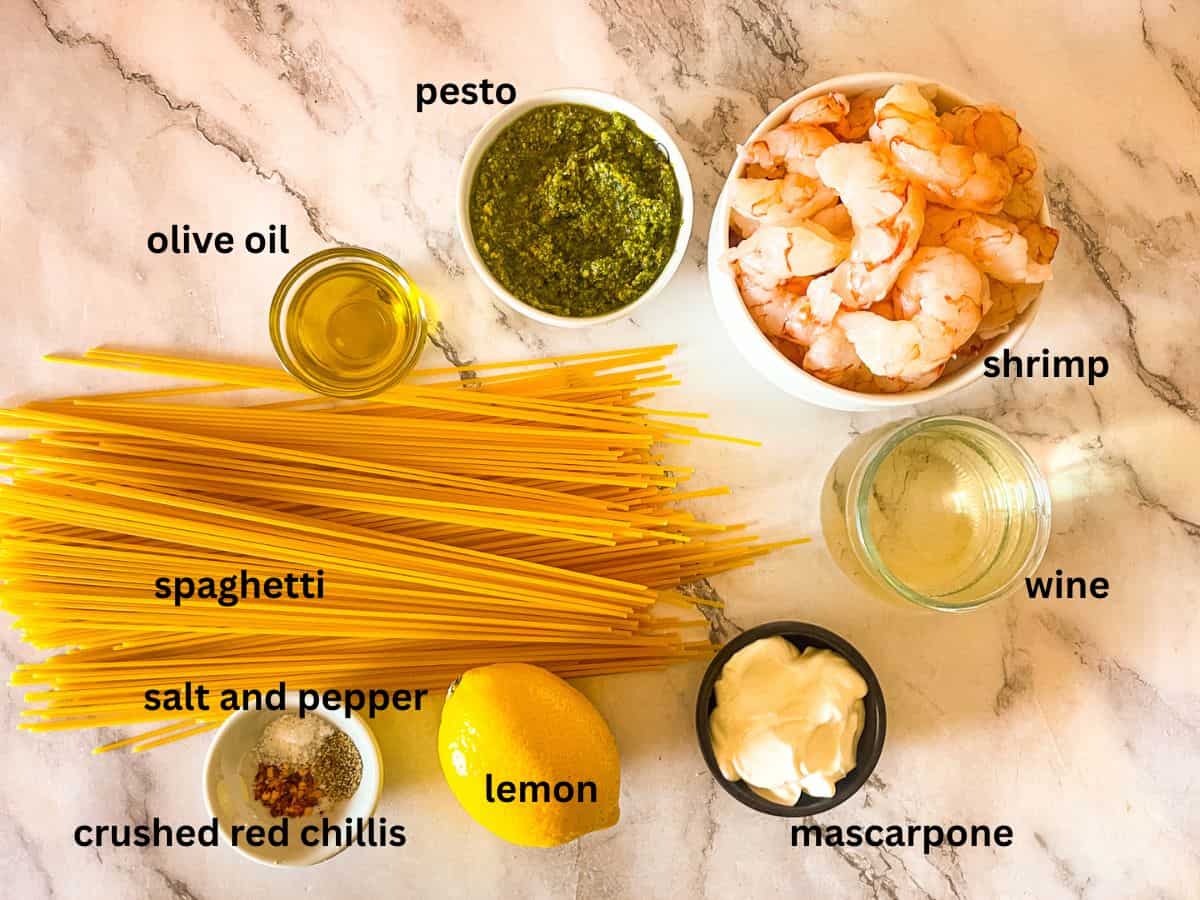 Ingredients for spaghetti pesto pasta on table.