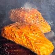 two pieces of salmon grilled on cedar planks.