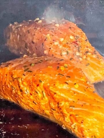 two pieces of salmon grilled on cedar planks.