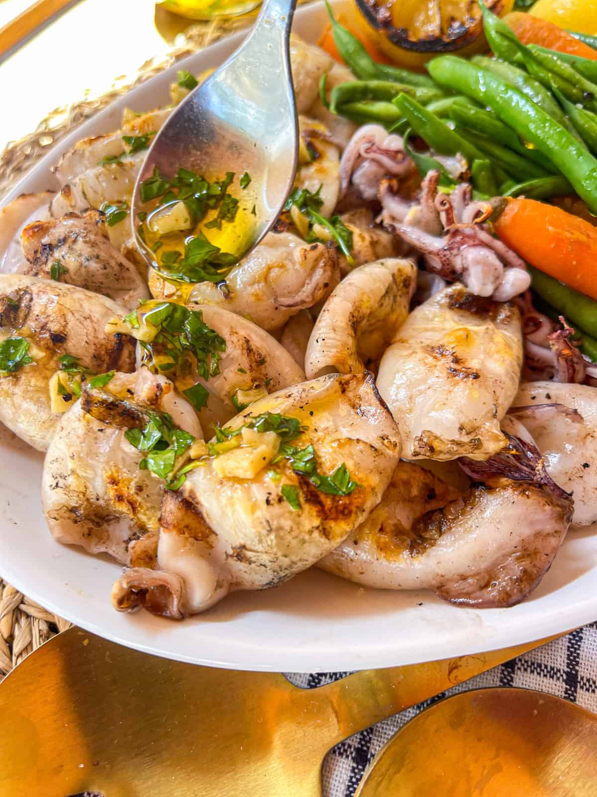 Garlic herb sauce drizzled over grilled calamari.