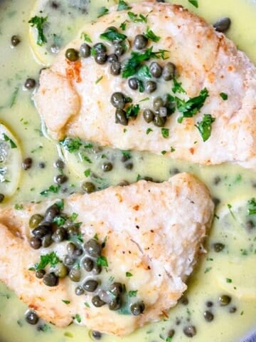 2 pieces of halibut cheeks in lemon piccata sauce.