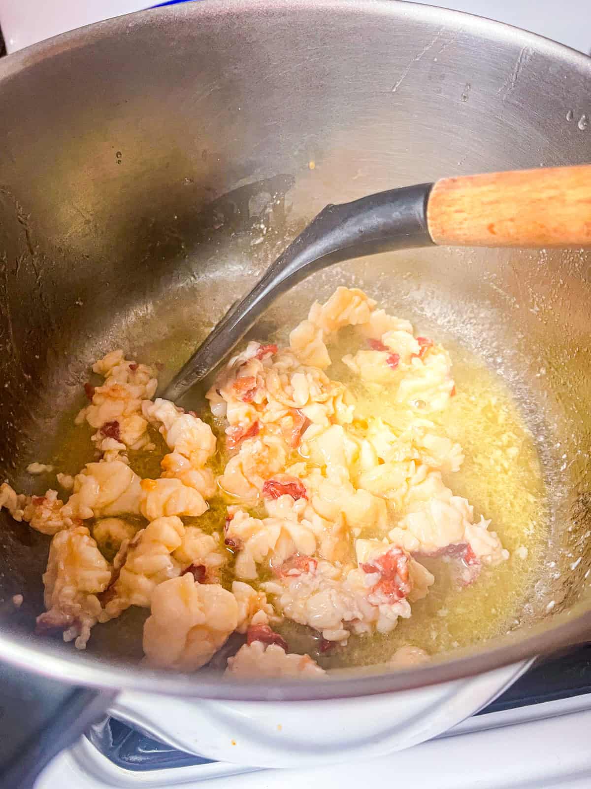 Sauté diced lobster in butter until it just starts turning opaque. Remove and set aside.