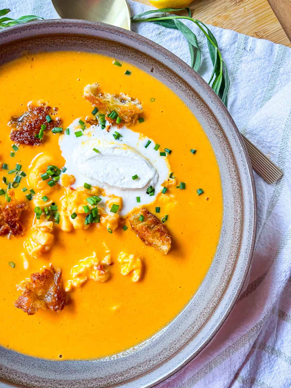 Ladle into bowls and top with lightly whipped cream, buttery croutons, and fresh chives.